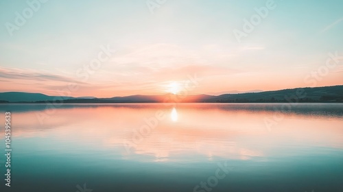 Wallpaper Mural A peaceful sunrise over a calm lake with mountains in the background. Torontodigital.ca