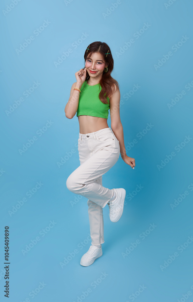Young Asia cute girl feel happy with positive expression, joyful surprise laugh, dressed in casual cloth isolated on blue background. Young Asia cute girl feel happy with positive expression, joyful surprise laugh, dressed in casual cloth isolated on blue background.