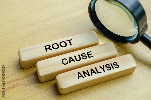 Bild auf Leinwand Root Cause Analysis text on wooden blocks with magnifying glass background