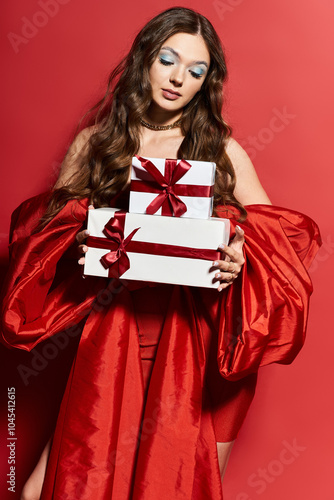 A stylish young woman gracefully presents beautifully wrapped gifts with excitement and joy.