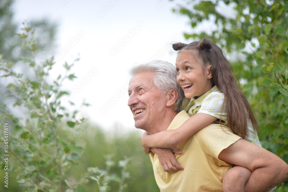 Portrait of a little girl with her grandfather in nature Portrait of a little girl with her grandfather in nature
