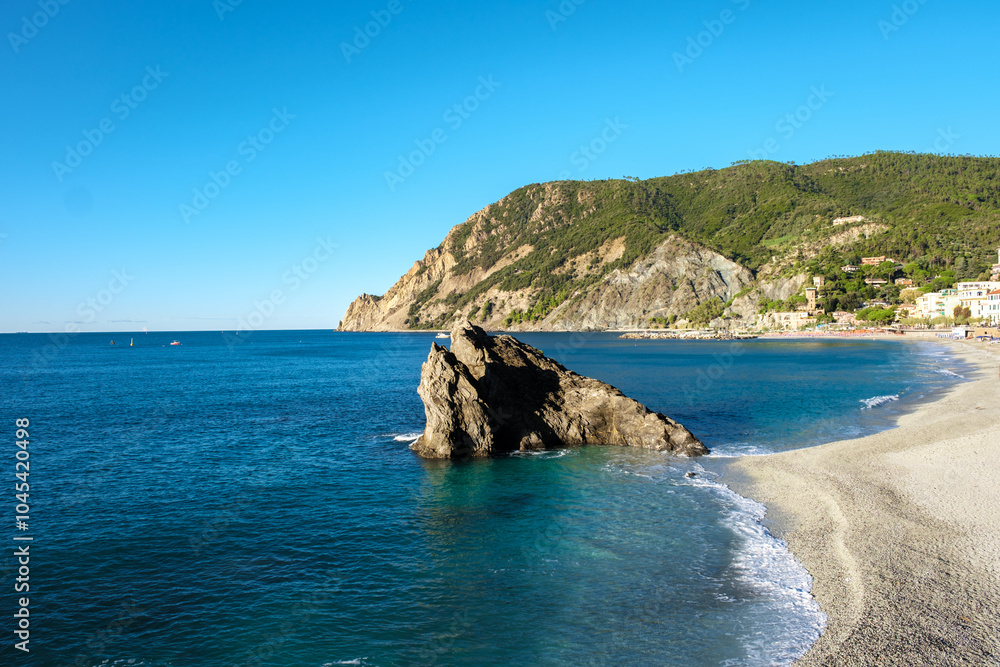 Explore the serene beaches and rocky coastlines of Cinque Terre, Italy during a sunny day Explore the serene beaches and rocky coastlines of Cinque Terre, Italy during a sunny day