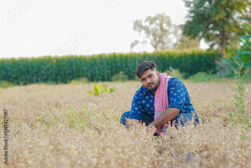 Young Indian smart farmer standing in wheat farm photo