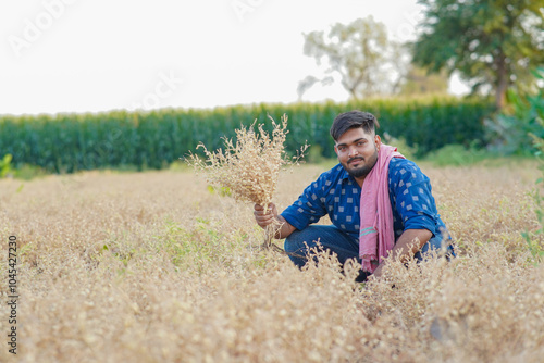 Young Indian smart farmer standing in wheat farm photo