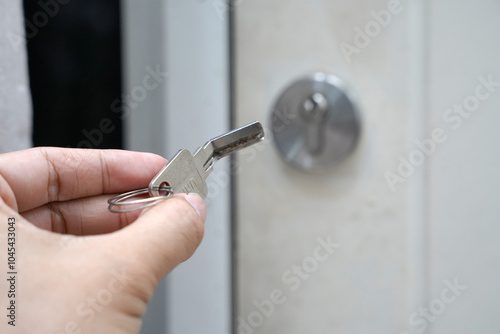 bent key or broken key with background of keyhole in the door.