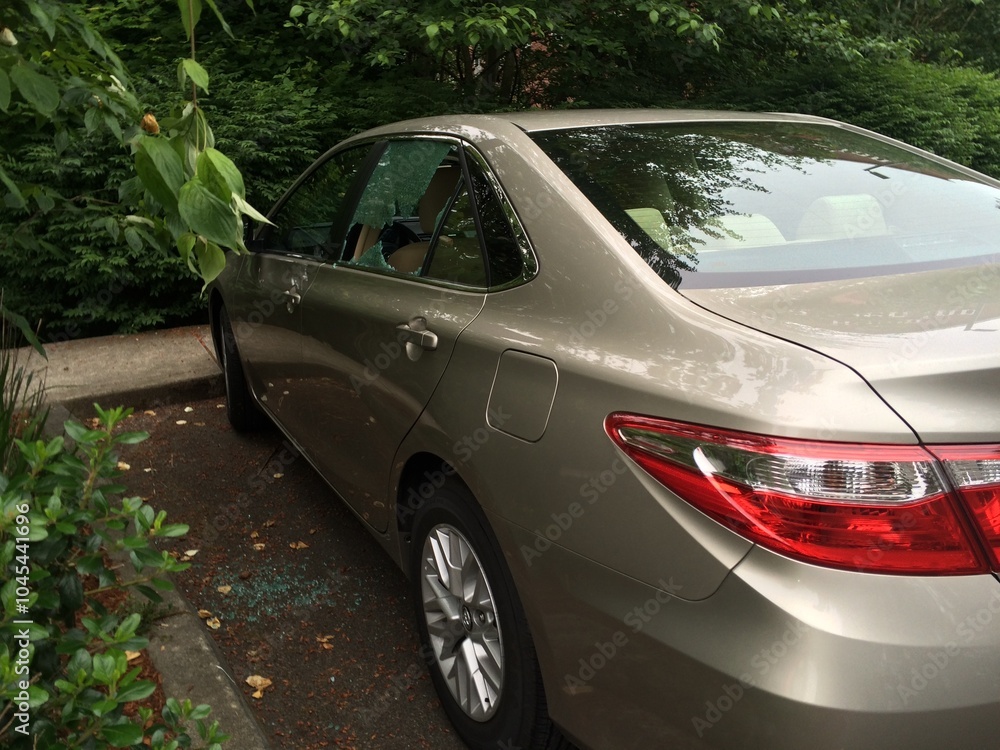 Broken Car Window on a Tan Sedan, Vandalism, Driver Side, Damaged Glass Broken Car Window on a Tan Sedan, Vandalism, Driver Side, Damaged Glass