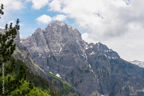 Majestic mountain ridge Maja Boshit towering over rugged landscape in Albanian Alps (Accursed Mountains) in Northern Albania. Scenic hiking trail from Valbona to Theth. Wanderlust in alpine wilderness photo