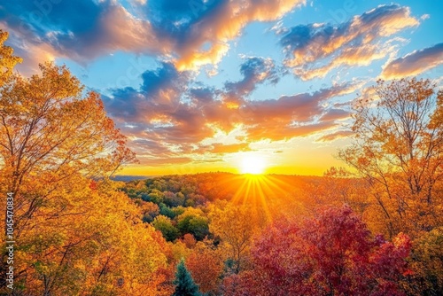 A vibrant autumn sky at sunset, with the golden sun setting behind the horizon, filling the sky with rich autumn colors