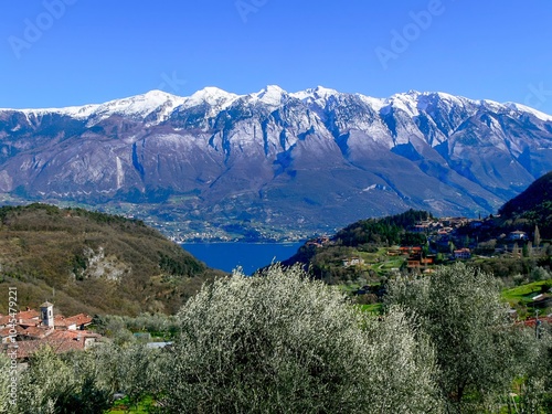 View of Priezzo, a municipality in the Comune Tremosine. In the background is the mountain range of the snow-covered Monte Baldo. photo