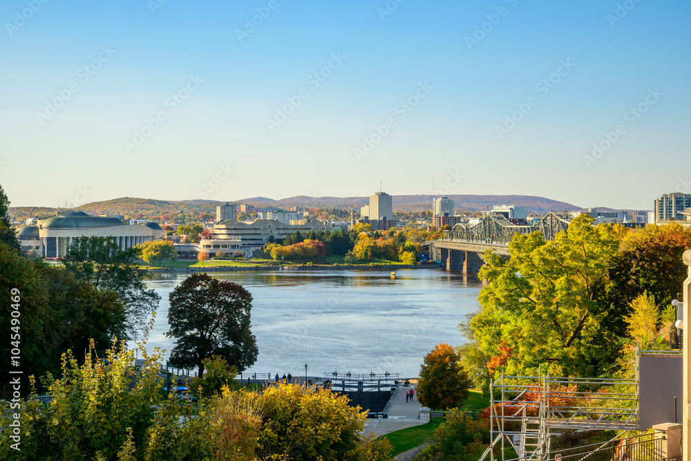 Fototapeta premium Looking across the Ottawa River from the locks of Rideau Canal at the base of Parliment Hill to Quebec and the City of Gatineau on a sunny fall day room for text