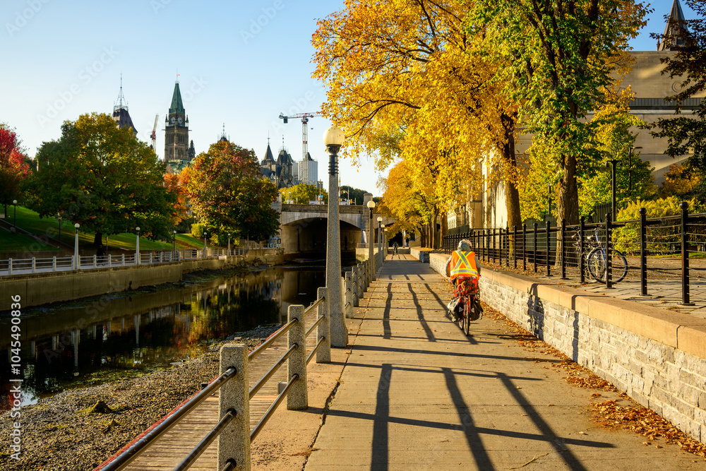Obraz premium The path alongside the Rideau Canal in Ottawa is popular with locals and visitors alike seen here with fall colour