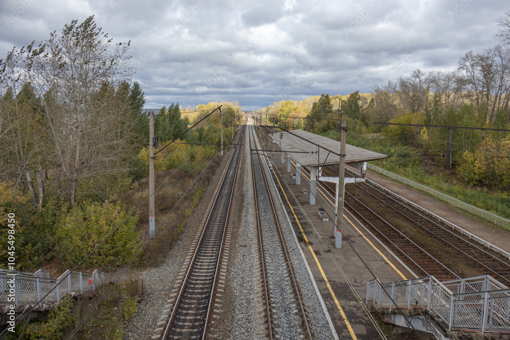 Railway station. The railway tracks pass through a small platform where people can board the carriages. A railway for transporting goods and transporting people. Railway station. The railway tracks pass through a small platform where people can board the carriages. A railway for transporting goods and transporting people.