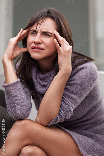 Young woman suffering from a strong headache