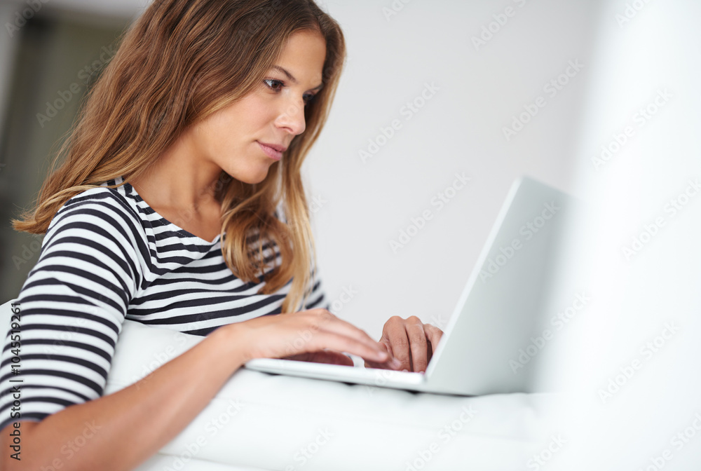 Typing, laptop and woman in living room for remote work, reading blog or relax on sofa. Freelancer, content writer and online in home for research and proofreading article for social media platform Typing, laptop and woman in living room for remote work, reading blog or relax on sofa. Freelancer, content writer and online in home for research and proofreading article for social media platform