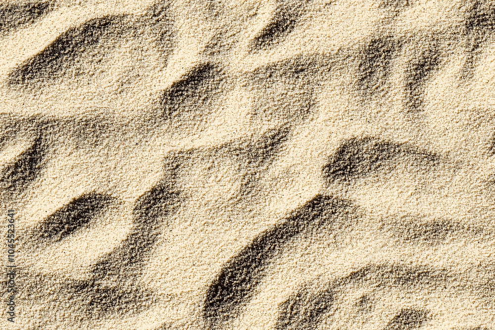 Close-up image of sand texture fine grains with subtle shadow Close-up image of sand texture fine grains with subtle shadow