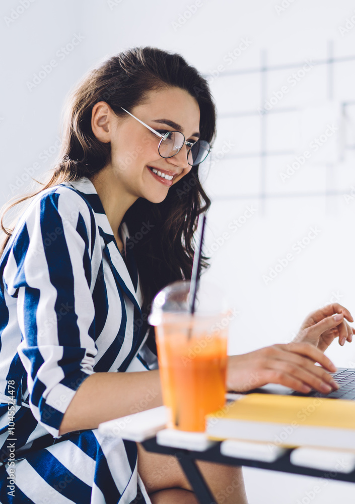 Smiling woman in glasses chatting online Smiling woman in glasses chatting online