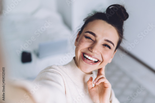 Free Download Attractive young woman using camera of smartphone taking sunny selfie at home - GFXLoad