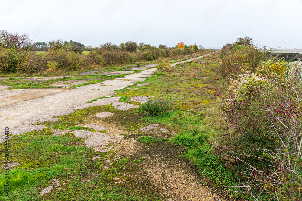 The remains of the concrete runway of the Second World War airfield of RAF Broadwell near the village of Kencot, Oxfordshire, England UK