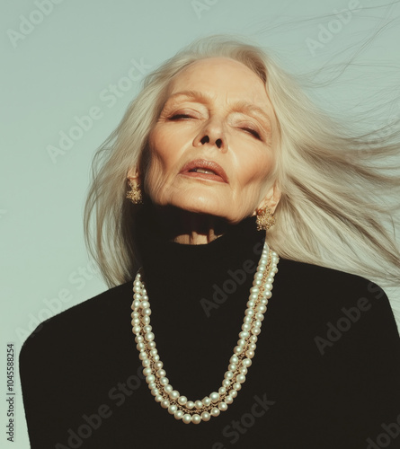 Edgy Jewelry portrait of Female senior fashion model, elderly, old woman, wearing a pearl necklace posing for fashion magazine. her hair is silver, natural beauty, aging gracefully concept