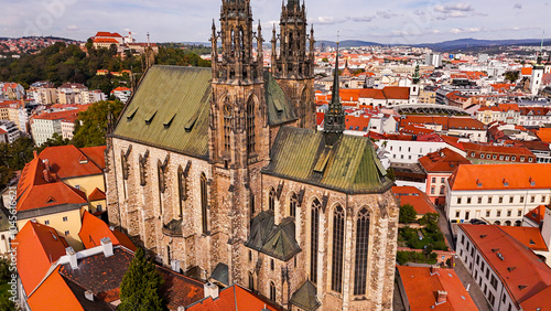 Brno, Czech Republic. Cinematic Aerial view to the Roman Catholic cathedral. Originally medieval in gothic style, many renovations, High towers added in Gothic revival between 1901-1909. Aerial view. 