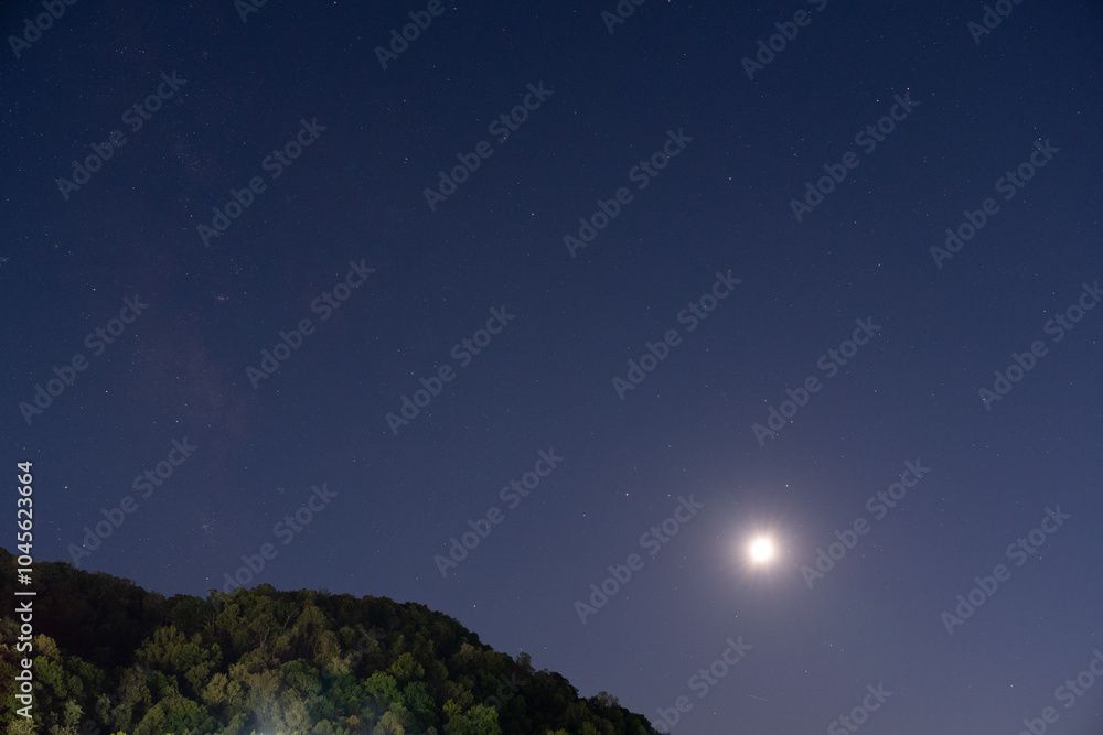 Starry Night Sky with Moon Over Forested Hill. Starry Night Sky with Moon Over Forested Hill.