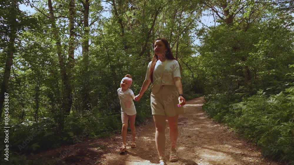 Mom and daughter walking in nature, a child walking with his mother, a girl with her mother walking in nature Mom and daughter walking in nature, a child walking with his mother, a girl with her mother walking in nature