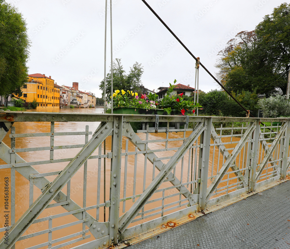 iron bridge railing and the river at risk of flooding during the city flood iron bridge railing and the river at risk of flooding during the city flood