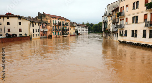 Fototapeta Naklejka Na Ścianę i Meble -  homes along the muddy riverbank are at risk of flooding after rains caused by global warming and climate change