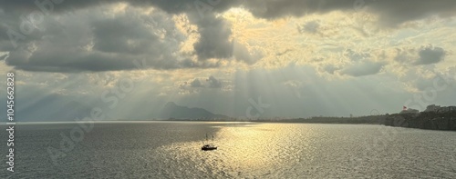 Obraz na płótnie Beautiful sky with sun rays shining on the boat in the Mediterranean Sea in Antalya, Turkey w salonie