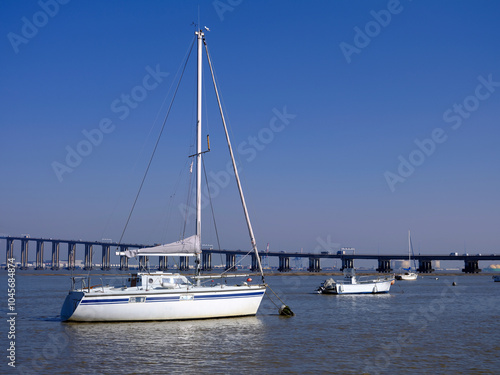 Sailboat and the big bridge of Saint Nazaire at Saint Brevin les Pins in Pays de la Loire region in western France