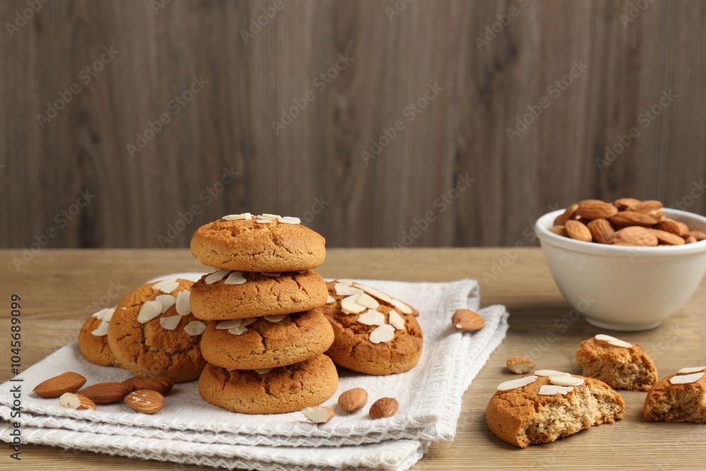 Tasty cookies with almond flakes and nuts on wooden table Tasty cookies with almond flakes and nuts on wooden table