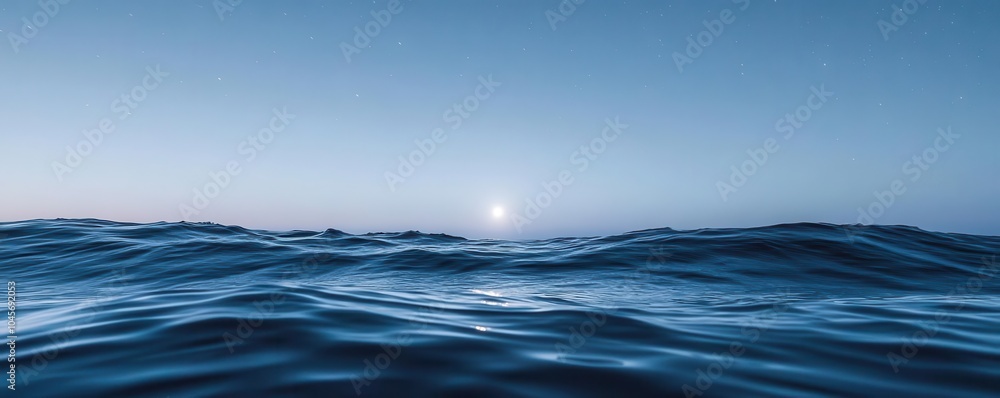 Fototapeta premium Peaceful moonlight touching the surface of a calm ocean, with small waves gently rolling under the starry night sky