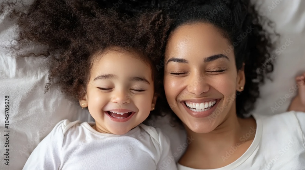 A joyful moment shared between a mother and her child, both laughing, reflecting the warmth and connection of family bonds and playful affection. A joyful moment shared between a mother and her child, both laughing, reflecting the warmth and connection of family bonds and playful affection.