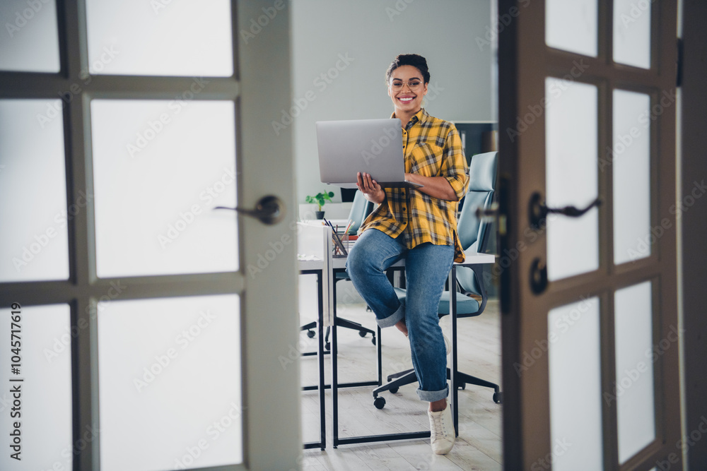 Full body photo of young woman sit table work netbook wear yellow plaid shirt comfortable modern office room interior indoors workspace Full body photo of young woman sit table work netbook wear yellow plaid shirt comfortable modern office room interior indoors workspace