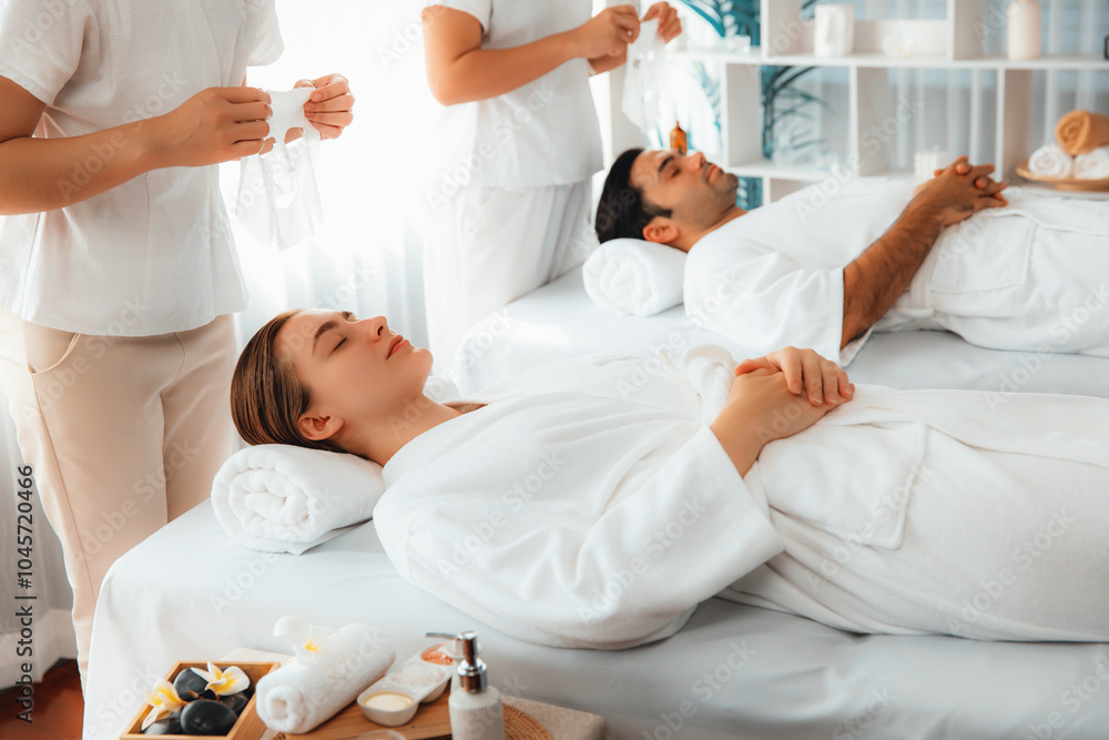 Obraz premium Serene modern daylight ambiance of spa salon, couple customer indulges in rejuvenating with facial skincare mask. Facial skin treatment and beauty cosmetology procedure for face. Quiescent