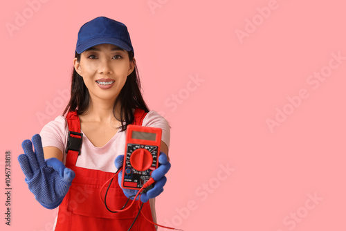 Young female electrician wi...