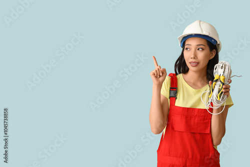 Young female electrician wi...