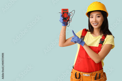 Young female electrician po...