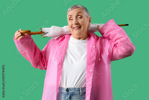 Senior woman in raincoat wi...