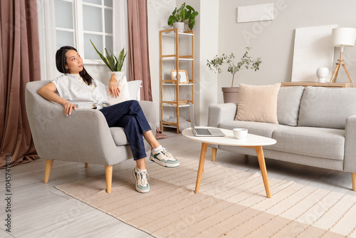 Young Asian woman sitting i...