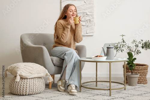 Young woman with cup of tea...