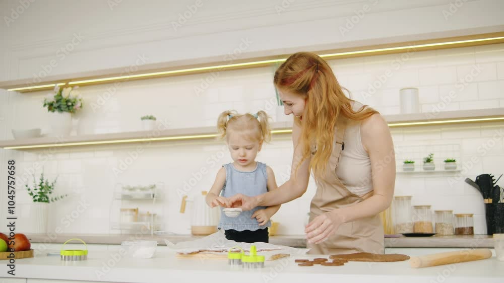 A red haired mother and her little daughter joyfully engage in baking together in their modern kitchen, creating delicious treats and cherished memories A red haired mother and her little daughter joyfully engage in baking together in their modern kitchen, creating delicious treats and cherished memories