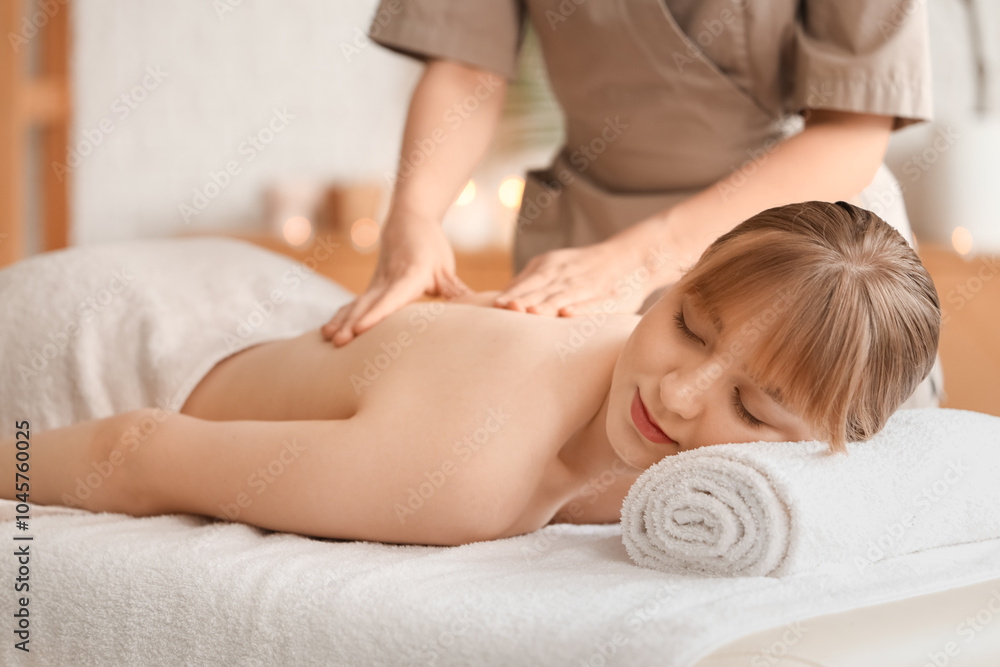 Young woman undergoing massage procedure in spa salon Young woman undergoing massage procedure in spa salon