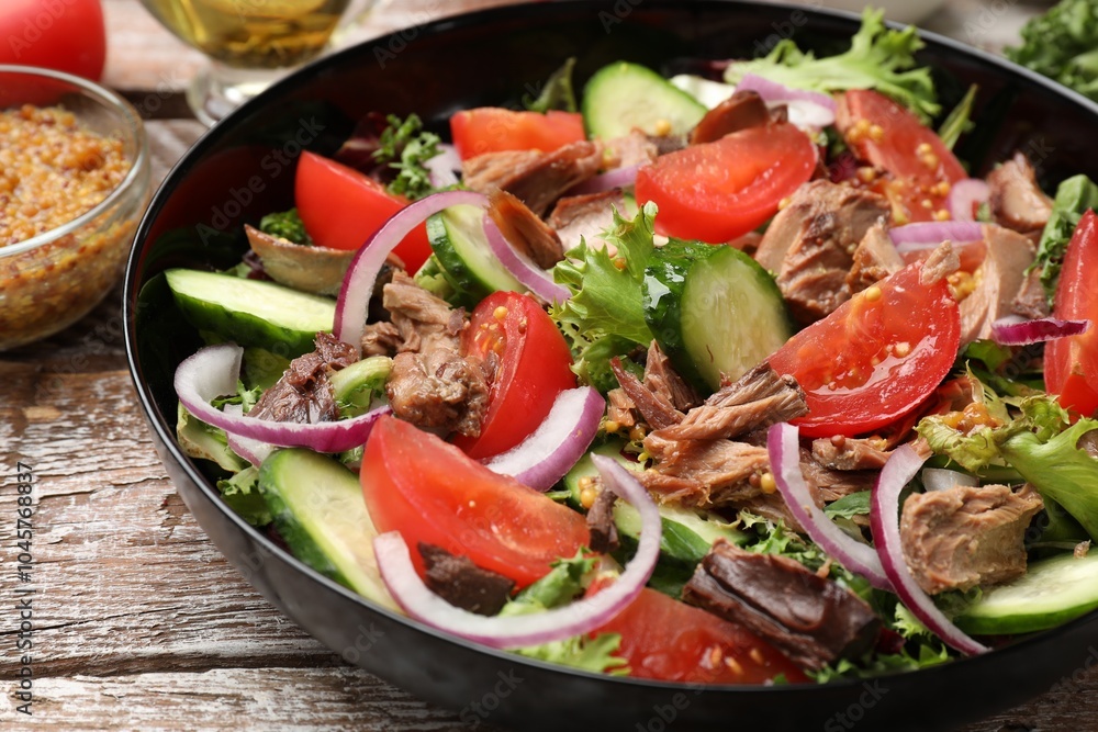 Delicious fresh tuna salad on wooden table, closeup Delicious fresh tuna salad on wooden table, closeup