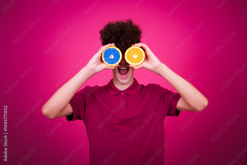 Beauty and health care. Funny guy and oranges. Pink background. Beauty and health care. Funny guy and oranges. Pink background.