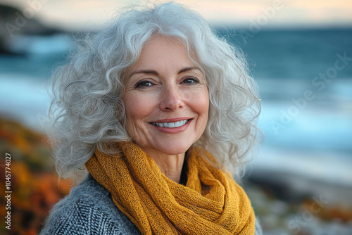 Portrait in the beach of a pleased 50 years old woman in fall. Lifestyle portrait photography of a satisfied woman in her 50s against a beach background.