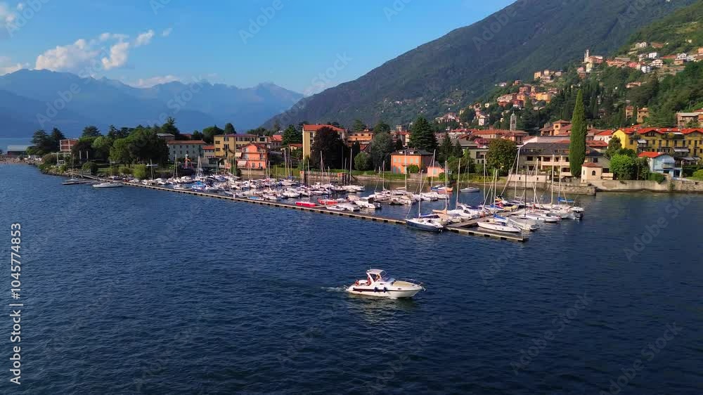 Aerial view of moored white sailing yachts and motor boats in a small port on the lake. Trips. Tourism. Mountains around the lake. Fresh water. Green Planet. Sailing yacht. Italy, Bellano, 15.07.2024 Aerial view of moored white sailing yachts and motor boats in a small port on the lake. Trips. Tourism. Mountains around the lake. Fresh water. Green Planet. Sailing yacht. Italy, Bellano, 15.07.2024