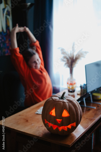 Wallpaper Mural Caucasian happy girl orange color cloths near carved Halloween pumpkin studying online laptop Torontodigital.ca