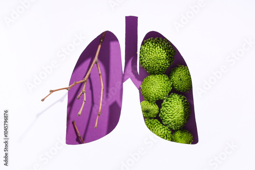 Paper cut out lungs with branches and flowers on purple background