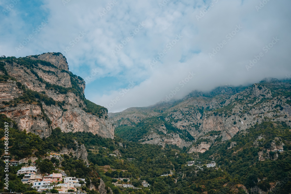 Amalfi coast, Italy. A beautiful Amalfi coast, Positano town with colorful houses on the cliff, green hills. Cloudey summer day in Positano. Mountains and green forest. Amalfi coast, Italy. A beautiful Amalfi coast, Positano town with colorful houses on the cliff, green hills. Cloudey summer day in Positano. Mountains and green forest.